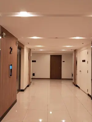 a hallway of an office building with two doors at Dhayz Staycation in Manila