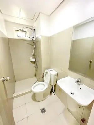 a bathroom with a toilet and a sink at Shore Residences 2 Bedroom Near NAIA Airport and MOA in Manila