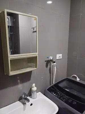 a bathroom with a sink and a mirror at Urban Space 1BR with Balcony in Manila