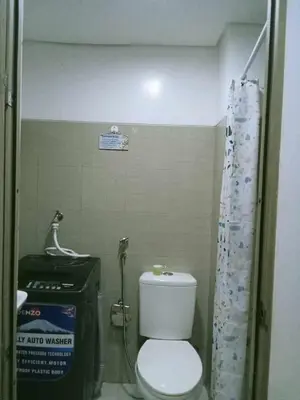 a small bathroom with a toilet and a sink at Francheska Suite near Mall of Asia in Manila