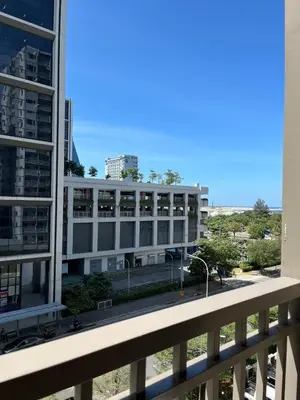 a large white building in front of a building at Francheska Suite near Mall of Asia in Manila