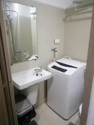a bathroom with a white toilet and a sink at Gorgeous 1BR Condo Unit near MOA and Manila Int'l Airport in Manila
