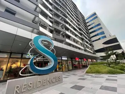 a building with a s sign in front of it at Gorgeous 1BR Condo Unit near MOA and Manila Int'l Airport in Manila