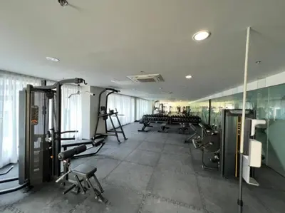 a gym with treadmills and machines in a room at Gorgeous 1BR Condo Unit near MOA and Manila Int'l Airport in Manila