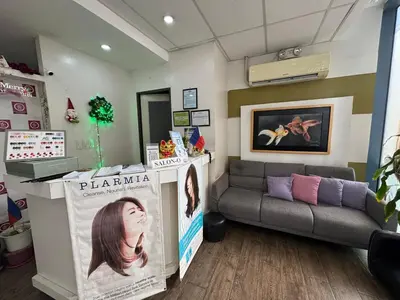 a waiting room with a couch and a newspaper at Grand Riviera Suites 1202 front of US Embassy by Prime Stay in Manila