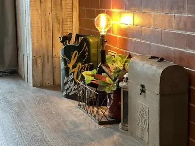 a lamp sitting on a chest next to a brick wall at LIXURY SUITES in S Residence Condo Pasay City in Manila