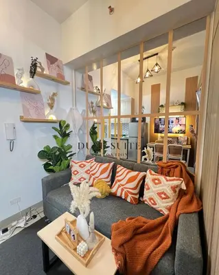 a living room with a couch and a table at Cozy Vibes near MOA & NAIA AIRPORT with NETFLIX,MINIVIDEOKE,BOARDGAMES-DUXE6 in Manila