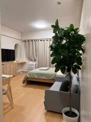 a bedroom with a bed and a potted plant at Morgan Suites Executive Residences 3 in Manila