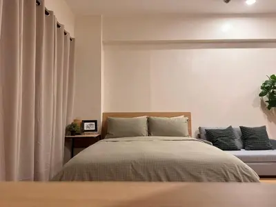 a bedroom with a bed and a couch at Morgan Suites Executive Residences 3 in Manila