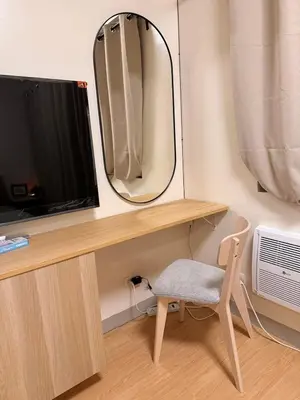a desk with a mirror and a chair and a television at Morgan Suites Executive Residences 3 in Manila
