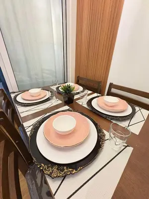 a table with plates and hats on top of it at Bahay-Bahayan in Manila