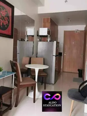 a room with a table and chairs and a kitchen at Aldo shore 3 tower 2 mall of Asia in Manila