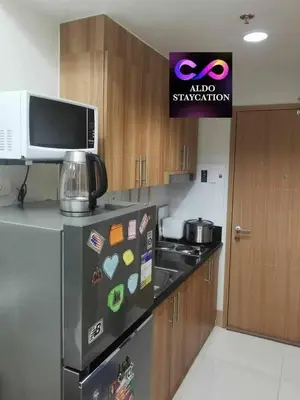 a kitchen with a refrigerator and a microwave at Aldo shore 3 tower 2 mall of Asia in Manila