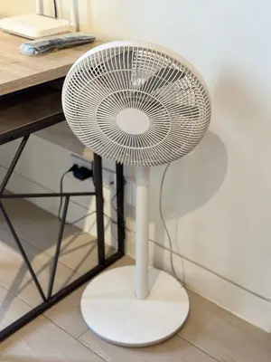 a white fan sitting next to a desk at Studio in Greenbelt with Wifi, Pool and Gym in Manila