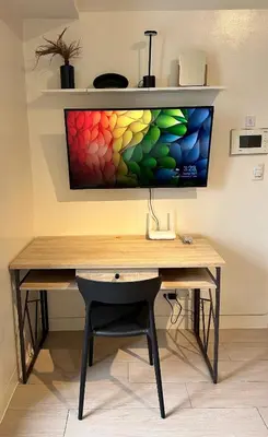 a desk with a computer monitor on a wall at Studio in Greenbelt with Wifi, Pool and Gym in Manila