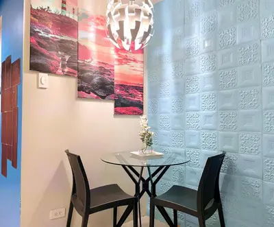 a dining room with a table and two chairs at MOA Shell Residences - Big Balcony Facing Pool in Manila