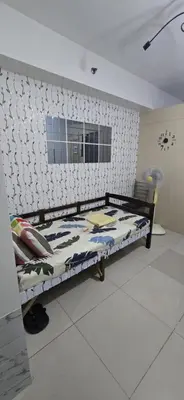 a bed in a room with a wall at Jhang places sea residence in Manila