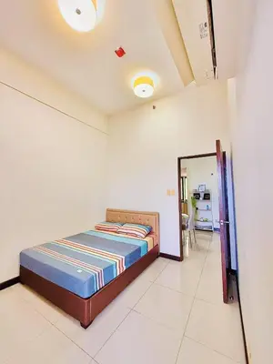 a bedroom with a bed and a mirror in it at Admiral Baysuites 2823 in Manila