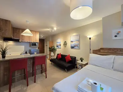 a room with a bed and a kitchen and a living room at 1BR Condotel Ridgewood Towers Taguig City #RW16 in Manila