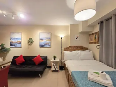 a hotel room with a bed and a couch at 1BR Condotel Ridgewood Towers Taguig City #RW16 in Manila