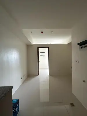an empty room with a hallway with a door at Grand View Tower in Manila