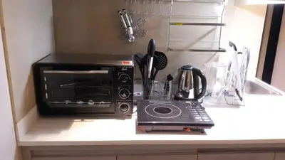 a microwave oven sitting on a counter in a kitchen at Araneta Cubao No Brown Outs 1BR Furnished Condo with Balcony free WiFi Netflix in Manila