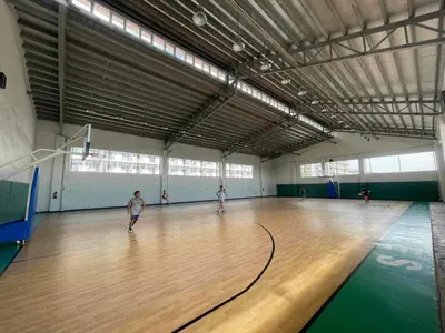 a group of people playing a game of bowling in a gym at Field Residences King Elite Near NAIA Arport in Manila