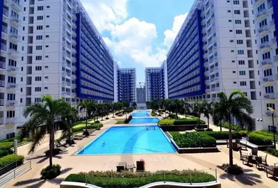 a large swimming pool in front of tall buildings at Sea Residence in Manila