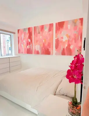 a bedroom with a white bed with a flower on a table at Le Luxe 102 by Ara li in Manila