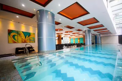 a large swimming pool in a hotel lobby at UPad Taft in Manila