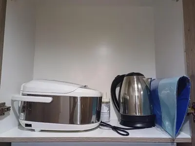 a toaster and coffee maker sitting on a shelf at Cozy and Comfortable 1BedRoom at Coast Residences in Manila