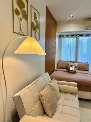 a living room with a couch and a bed at ElixirStaycation at Knightsbridge Residences in Manila