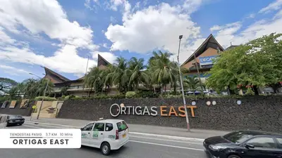 a white car parked in front of a building at Affordable Fully Furnished Place in the City in Manila