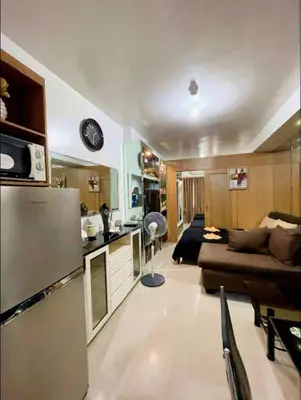 a kitchen and living room with a couch and a refrigerator at Shell Residence Tower A 250A in Manila