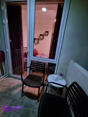a room with two chairs and a table and a window at 2BR with 2 balconies condo and Pool in Pasig in Manila