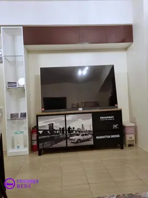 a large flat screen tv in a living room at 2BR with 2 balconies condo and Pool in Pasig in Manila
