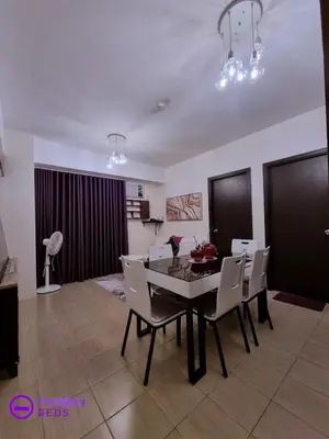 a dining room with a table and chairs at 2BR with 2 balconies condo and Pool in Pasig in Manila