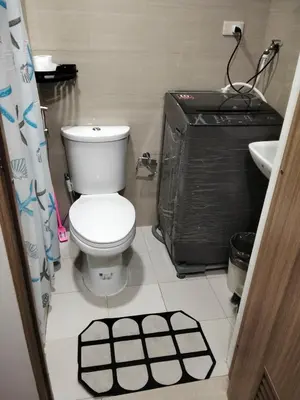 a bathroom with a toilet and a sink at VSV Luxury Family Suite staycation Moa in Manila