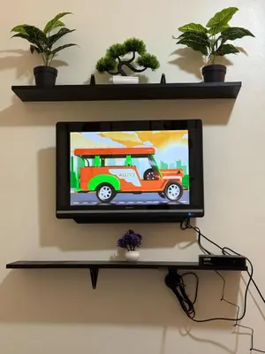 a television on a shelf with a bus on it at Condo in Cubao by Cindy in Manila