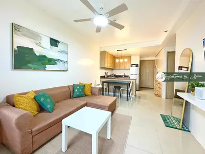 a living room with a couch and a table at Shore Residences 2 Bedroom with Balcony Near NAIA Airport MOA in Manila