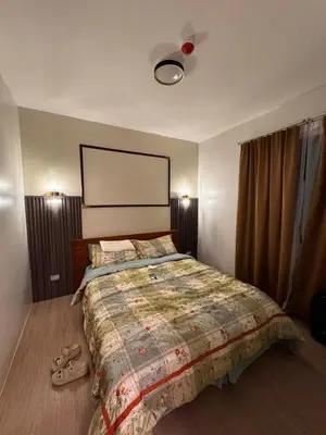 a bedroom with a large bed with a large bedspread at Mon Amour Haven in Taytay