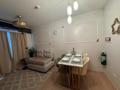 a living room with a table and a couch at Mon Amour Haven in Taytay