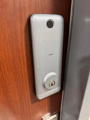 a cell phone is attached to a wooden door at Mon Amour Haven in Taytay