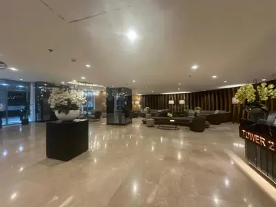 a lobby with couches and flowers in a building at Shore 2 Residence Homes Near MOA in Manila