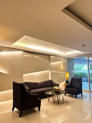 a living room with two couches and a table at Mariels Staycation in Manila