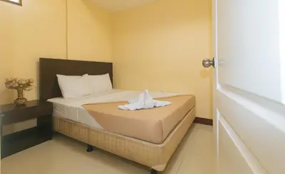 a small room with a bed with a towel on it at J and T Jamich Suites by RedDoorz in Manila