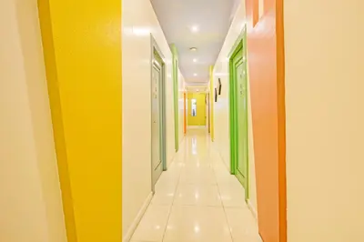 a hallway with yellow and green doors at VIP Hostel, Near PNR Pasay Evangelista, Makati Manila in Manila