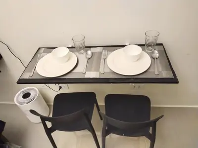 a table with two chairs and two white plates and cups at MJ Luxe Stays in Manila