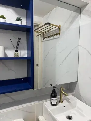 a bathroom with a sink and a mirror at 2BR Apartment in Pasig City in Manila