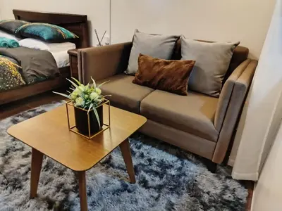 a living room with a couch and a coffee table at Modern-Studio with Balcony Stunning View in Manila